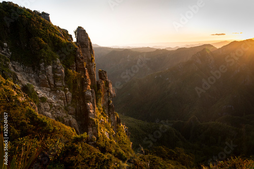 Setting sun lit up the valleys and cliffs of the Pinnacles, Coromandel, New Zealand photo