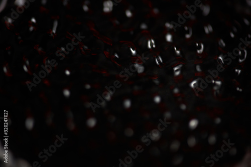 Abstract rippled background texture. Surface of water frozen in time, hi contrast lighting exposes the fascinating patterns created by soundwaves traveling directly through it. 