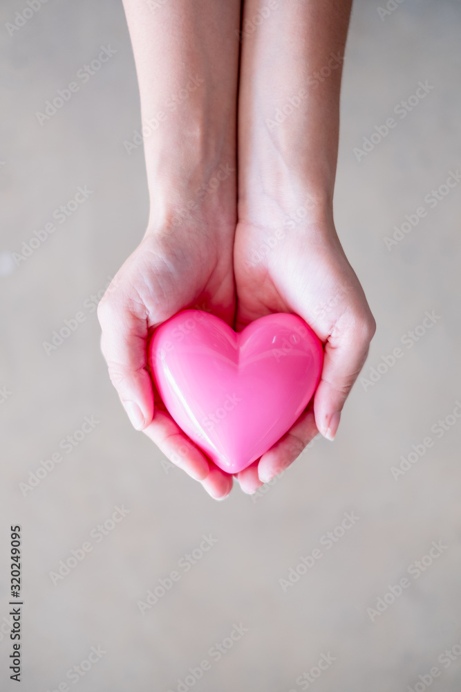 Female hand holding heart, concept of health , medicine and charity Female hand holding heart, concept of health , medicine and charity