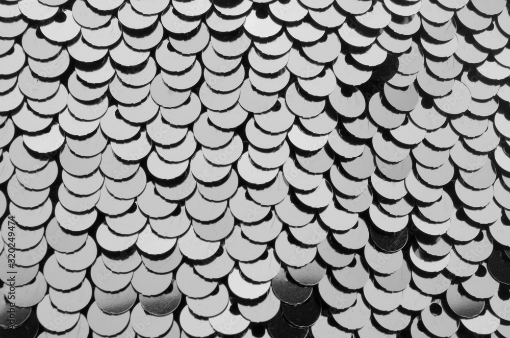 Silver metallic sequins textile background, close up, top view. Silver metallic sequins textile background, close up, top view.
