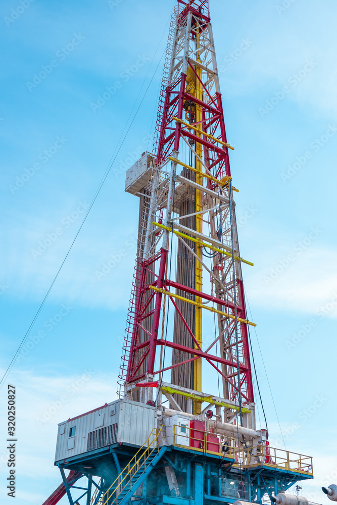 Oil and Gas Drilling Rig onshore dessert with dramatic cloudscape. Oil drilling rig operation on the oil platform in oil and gas industry Oil and Gas Drilling Rig onshore dessert with dramatic cloudscape. Oil drilling rig operation on the oil platform in oil and gas industry