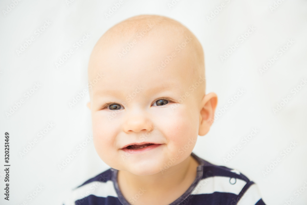 Portrait of a cute baby boy. Adorable one year old child looking funny and curious