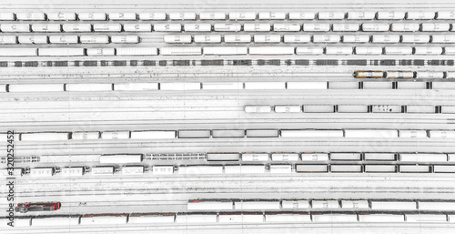 Aerial view of freight train yard covered in snow