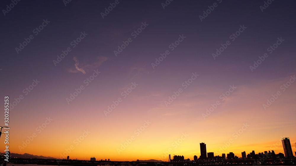 Blue and orange gradient sky background. Silhouette city space view (Taipei) with beautiful sunset sky.