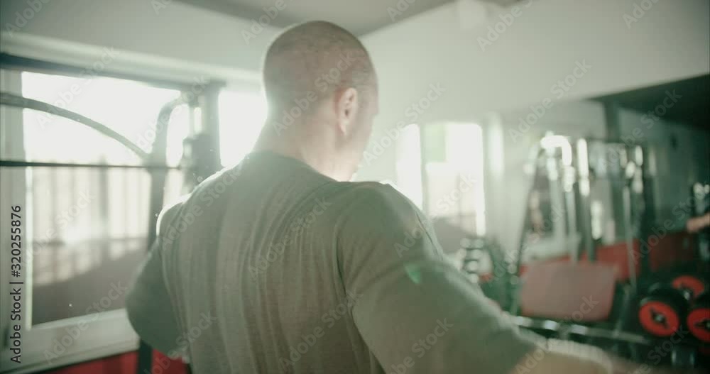 Bodybuilder is flexing his arm muscles in preparation of his heavy weight workout Bodybuilder is flexing his arm muscles in preparation of his heavy weight workout