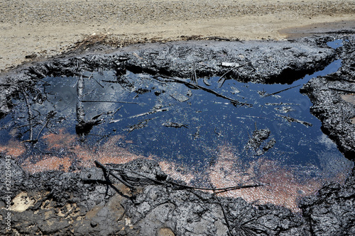 Industrial oil pollution on the surface of the soil is an environmental catastrophe.