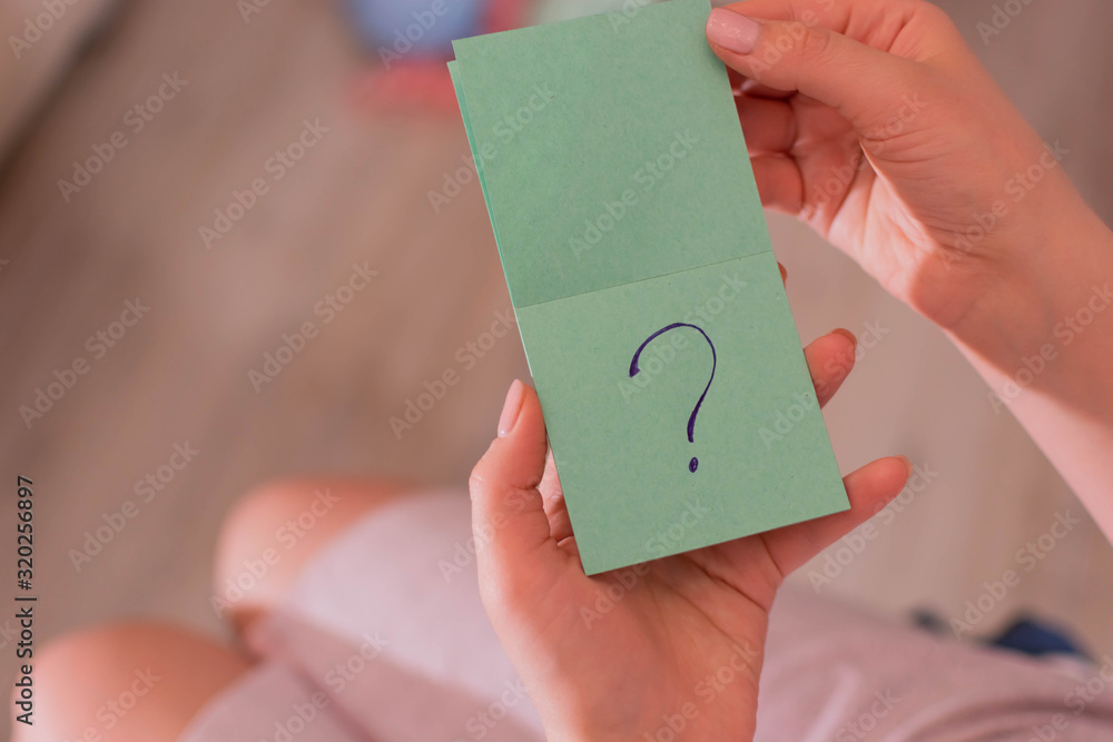 Question mark on a green piece of paper Question mark on a green piece of paper