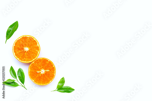 Fototapeta Naklejka Na Ścianę i Meble -  High vitamin C, Juicy orange fruit with leaves on white background.