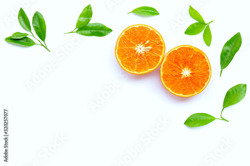 High vitamin C  Juicy orange fruit with leaves on white background.