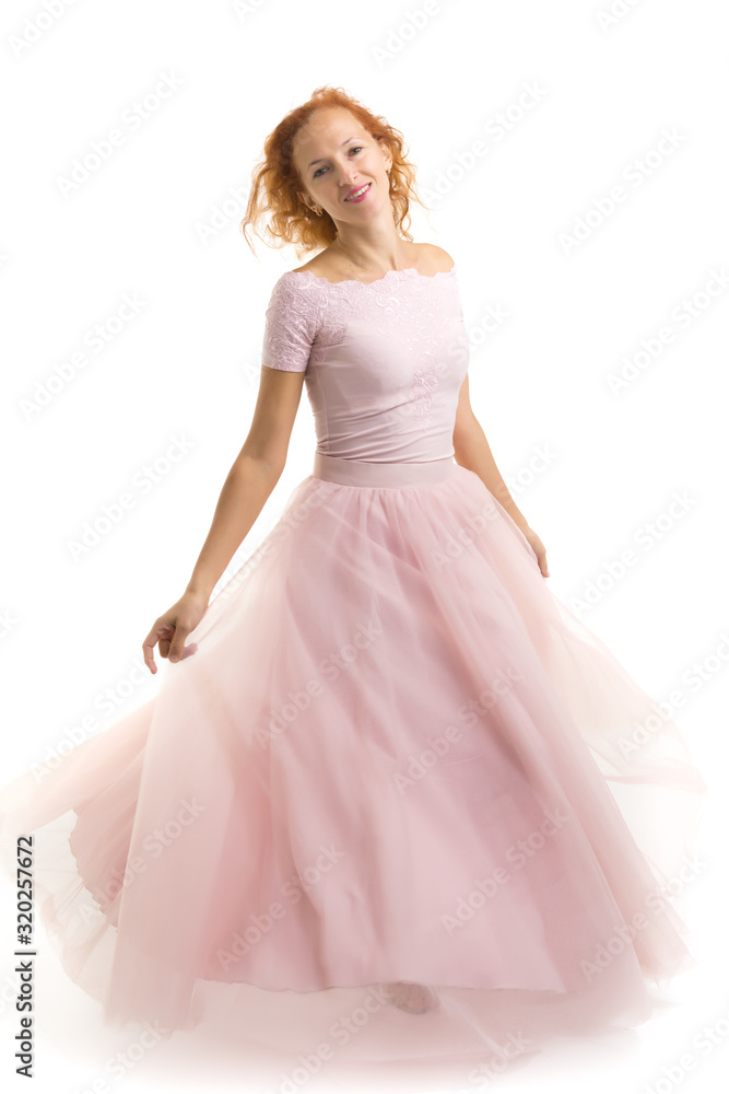 A beautiful young woman stands in the wind, the wind moves her c A beautiful young woman stands in the wind, the wind moves her c