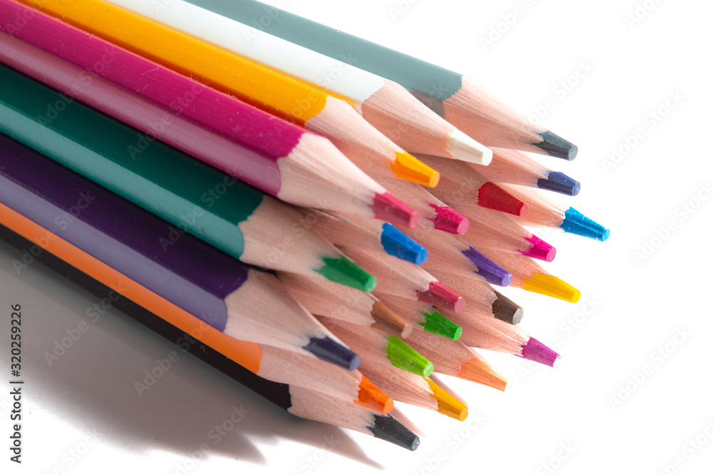 a stack of multi-colored pencils on a white background.