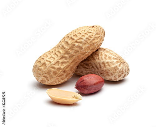 Dried peanuts in peel closeup isolated on white background photo