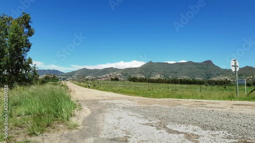 R712 road outside Clarens town in Free-state province South Africa with cars and motorbike traffic traveling past on vacation in Moluti Mountains. photo