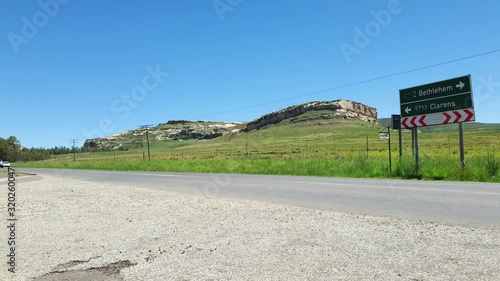 R712 road outside Clarens town in Free-state province South Africa with cars and motorbike traffic traveling past on vacation in Moluti Mountains. photo