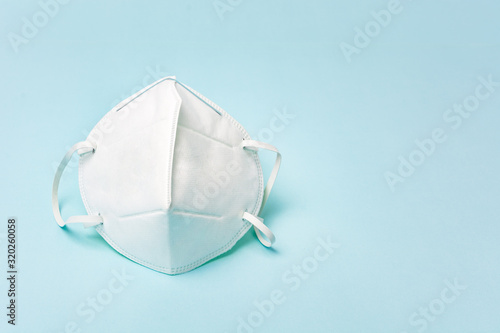 White medical face mask. Concept of coronavirus quarantine and ultra-fine microdust. Isolated of white background. Top view.