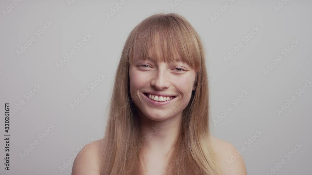 Beautiful cheerful redheaded woman standing and smiling isolated over white background. Amazing smile shows teeth Beautiful cheerful redheaded woman standing and smiling isolated over white background. Amazing smile shows teeth