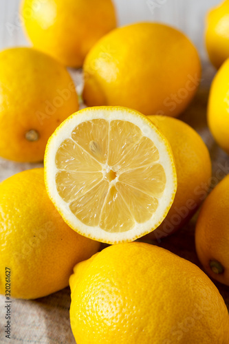 Obraz na płótnie Ripe Yellow Organic Lemons on cloth, side view. Close-up.