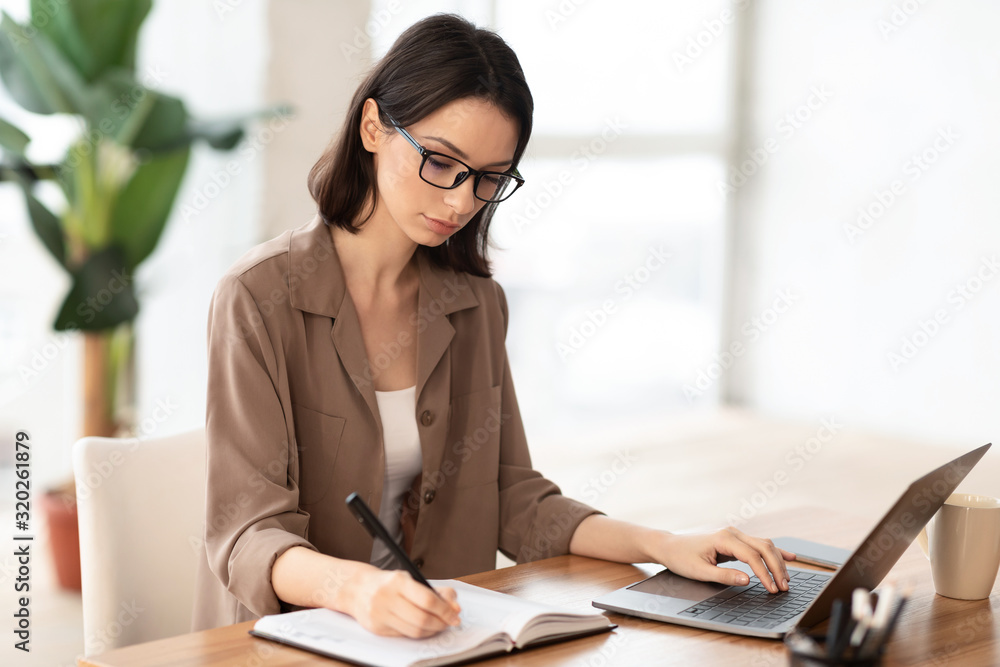 Portrait of manager taking notes typing on keyboard Portrait of manager taking notes typing on keyboard