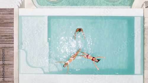 Group of friends having fun in private pool on Bali villa © Alena Ozerova