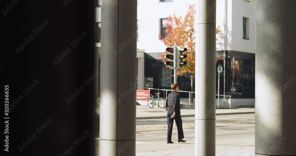 custom made wallpaper toronto digitalBusiness man wearing a suit walking through a building to a meeting.