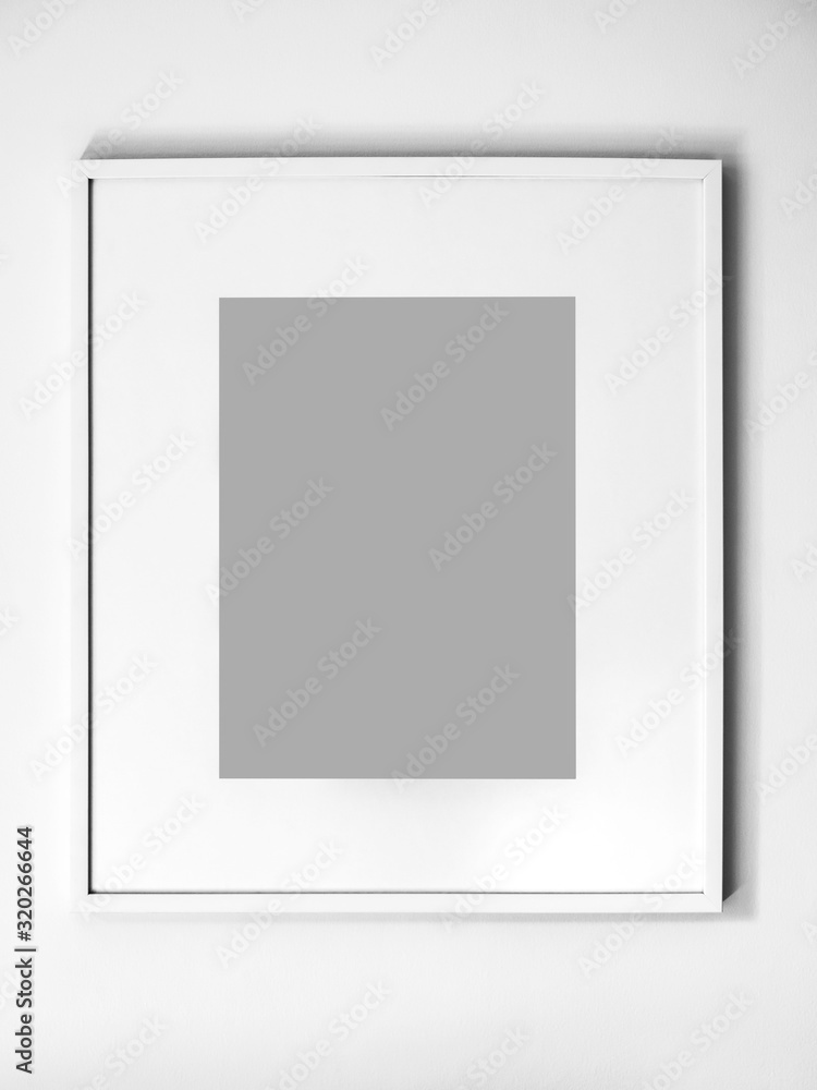 Blank white picture frame on white wall. Blank white picture frame on white wall.