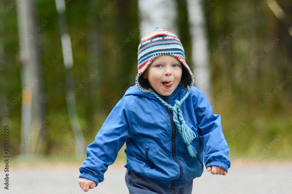 Happy cheerful boy with blue eyes running tongue out Happy cheerful boy with blue eyes running tongue out
