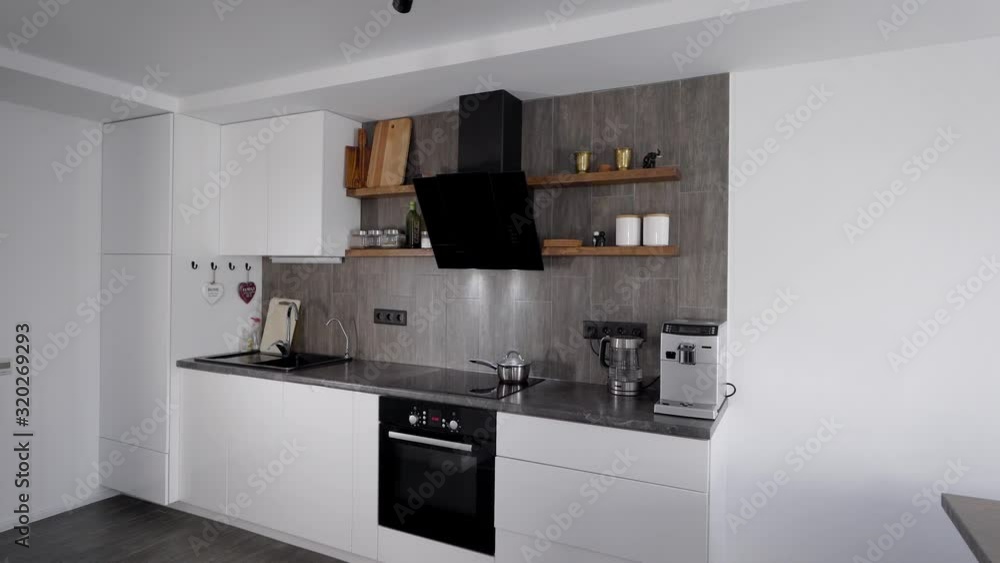 In the frame a modern, comfortable kitchen. Smart appliances are built into the minimalist interior. Natural materials in design. In the frame a modern, comfortable kitchen. Smart appliances are built into the minimalist interior. Natural materials in design.