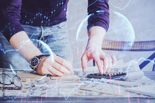 Multi exposure of man standing and planing investment with stock market forex chart.