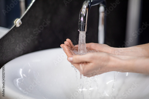 Unrecognizable Mature Woman Washing Hands In Bathroom  Selective Focus