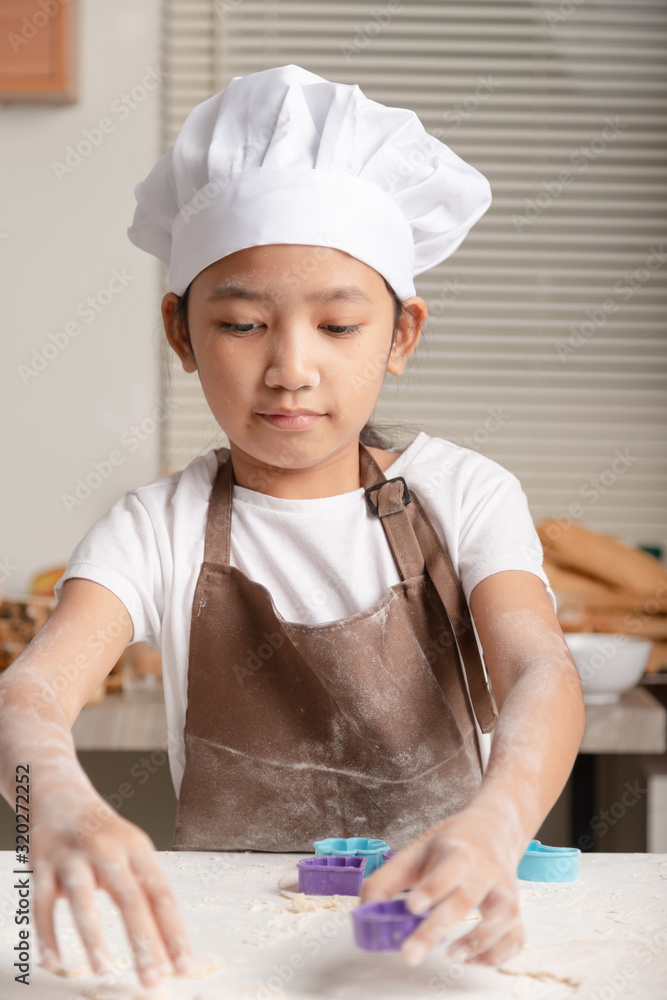 The little Asian girl making homemade bakery The little Asian girl making homemade bakery