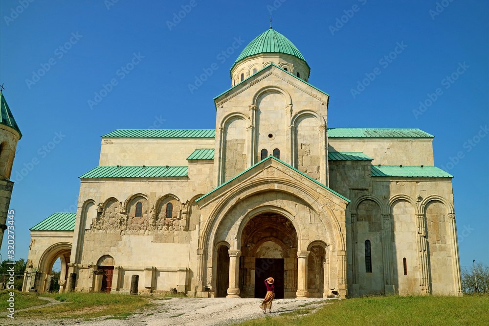 The Bagrati Cathedral or Cathedral of the Dormition with a Female Visitor at the Entrance, Kutaisi, Georgia