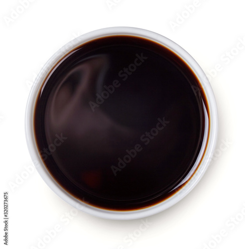 Bowl with soy sauce isolated on white background. Top view.