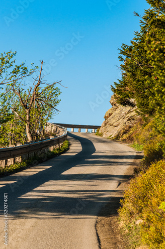 Mountain road between the rocks and forest