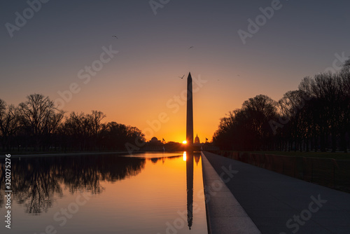 View of Capitol Building and Washington Monument reflecting in the Reflection Pool at sunrise