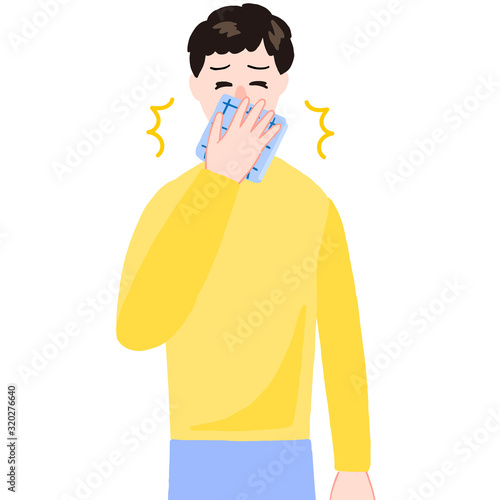 ハンカチをあててクシャミする男性