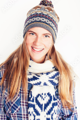 young pretty blond woman in hat and winter scarf smiling cheerful on white background, lifestyle people concept © iordani