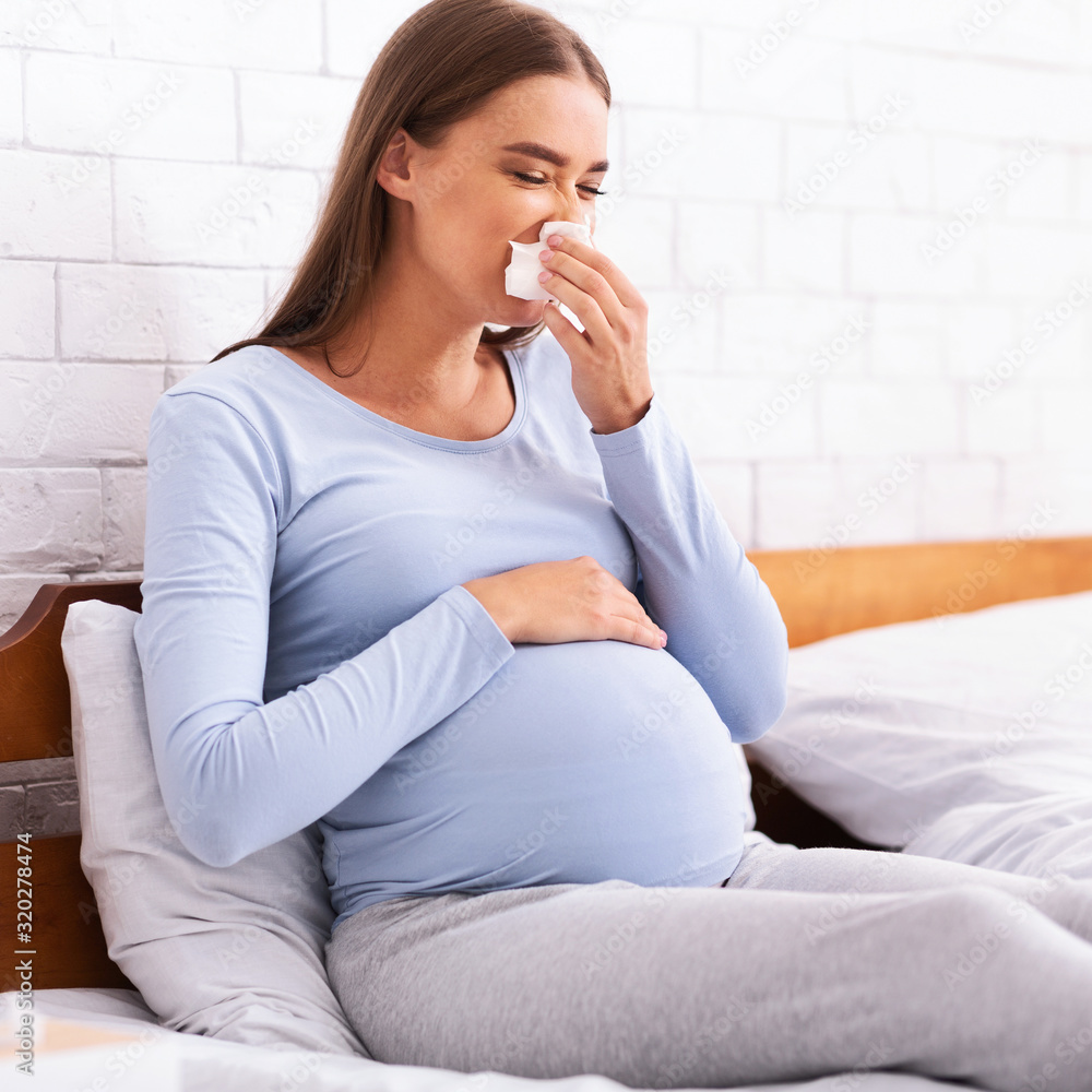 Sick Pregnant Lady Blowing Nose In Handkerchief Sitting In Bedroom Sick Pregnant Lady Blowing Nose In Handkerchief Sitting In Bedroom