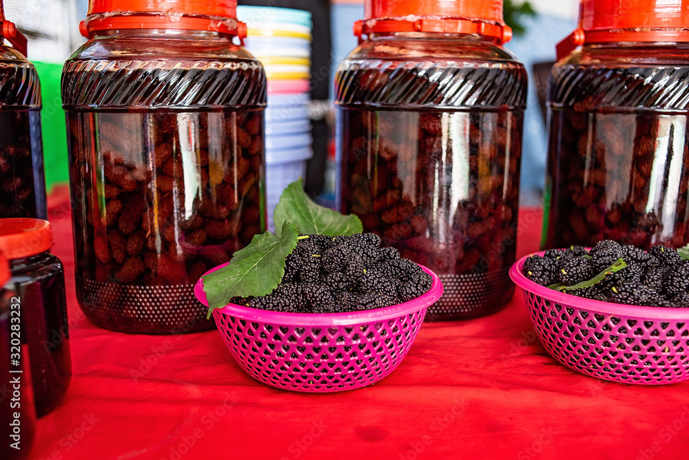 Freshly picked mulberry and mulberry wine Freshly picked mulberry and mulberry wine