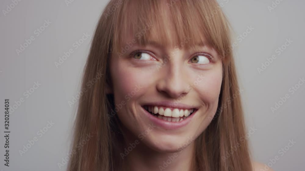 portrait of a happy smiling young beautiful woman, slow motion with white background portrait of a happy smiling young beautiful woman, slow motion with white background