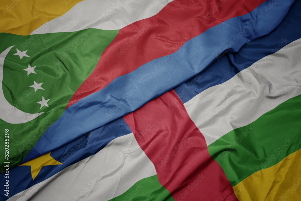 waving colorful flag of central african republic and national flag of comoros.