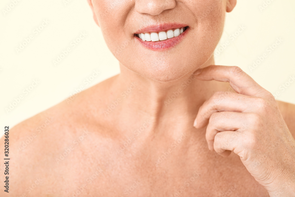 Beautiful mature woman with healthy skin on color background, closeup Beautiful mature woman with healthy skin on color background, closeup