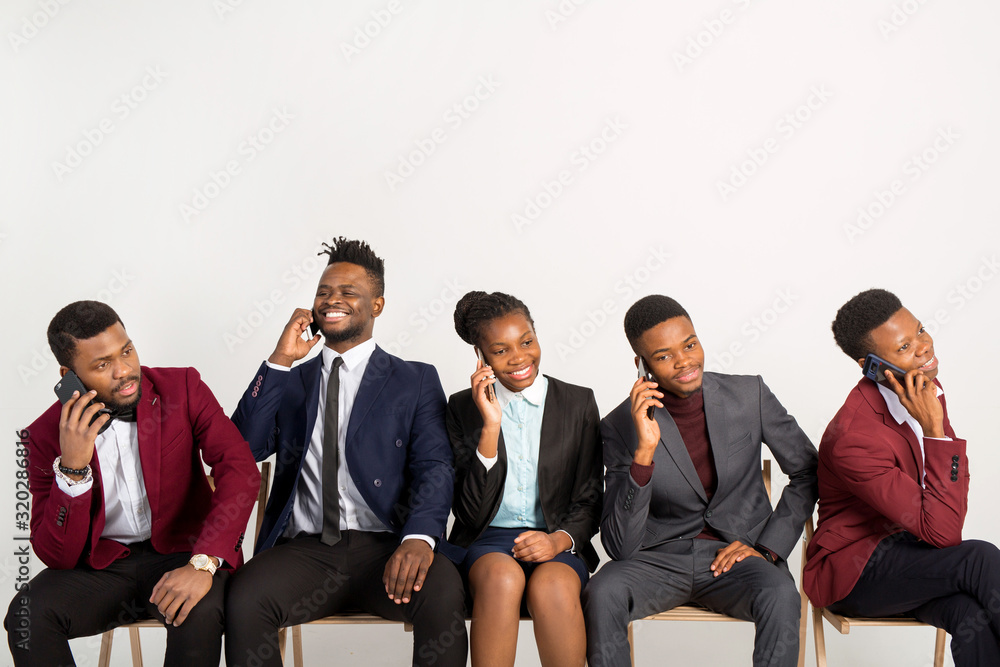 beautiful african people in suits on a white background with phones in their hands beautiful african people in suits on a white background with phones in their hands