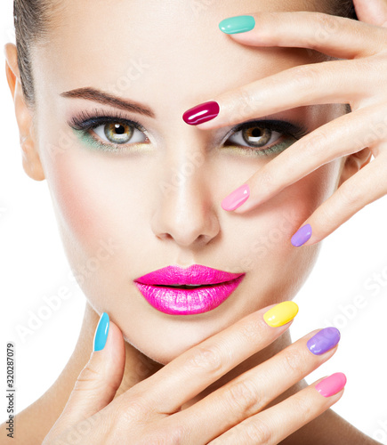 beautiful woman  with multicolor nails and fashion makeup