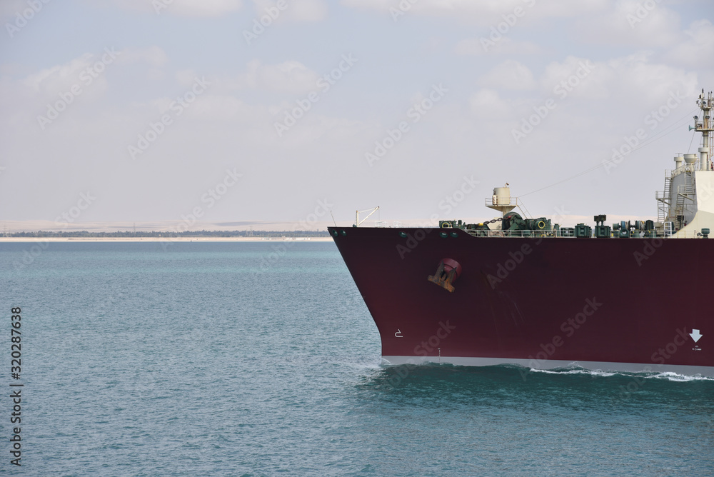 Large gas tanker ship transiting Suez Canal on a sunny day. Close view on the ships bow. Large gas tanker ship transiting Suez Canal on a sunny day. Close view on the ships bow.