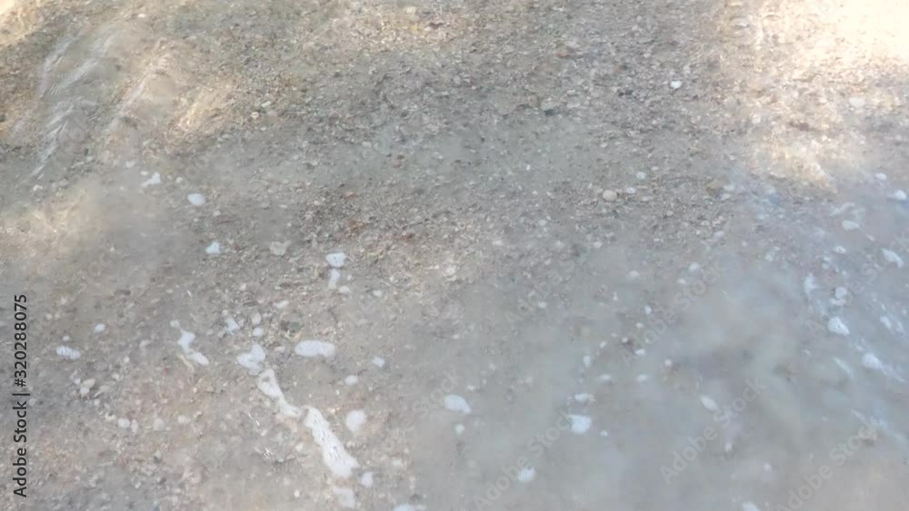 Clear tropical sea water running over white powder sand on a beach of Trat province in Thailand. Clear tropical sea water running over white powder sand on a beach of Trat province in Thailand.