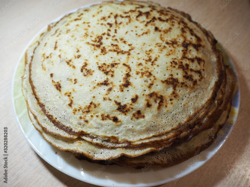 a stack of fried pancakes on a plate a stack of fried pancakes on a plate