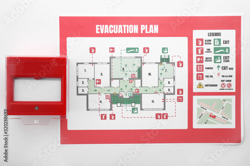 Evacuation plan and manual call point on white background photo