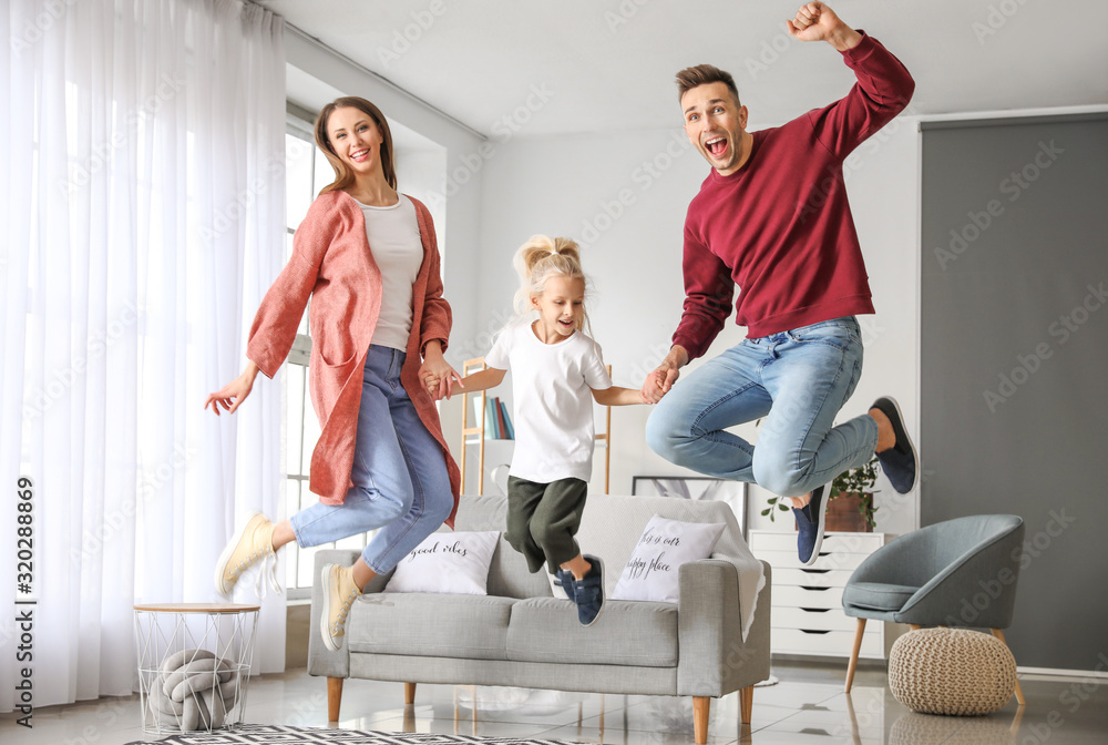 Obraz premium Happy family jumping at home