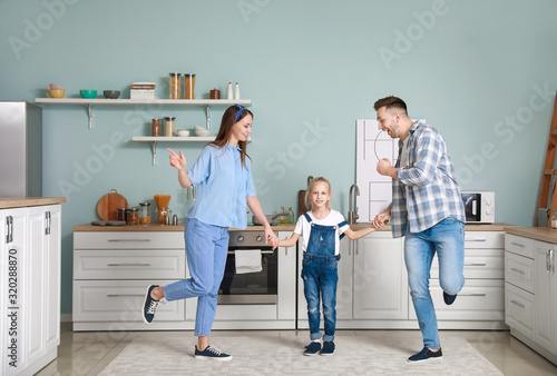 Happy family dancing in kit...