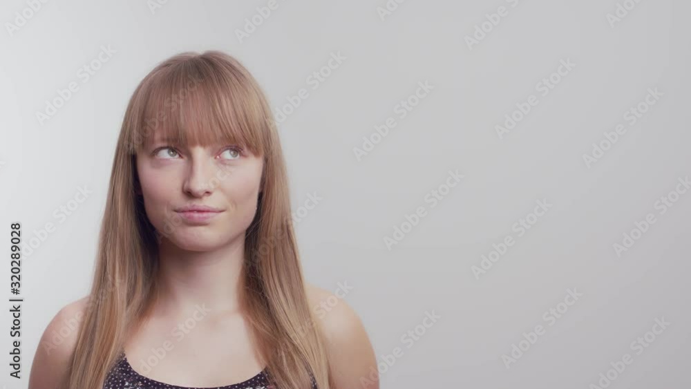Medium shot of a woman eye rolling on a white background in slow motion. Medium shot of a woman eye rolling on a white background in slow motion.